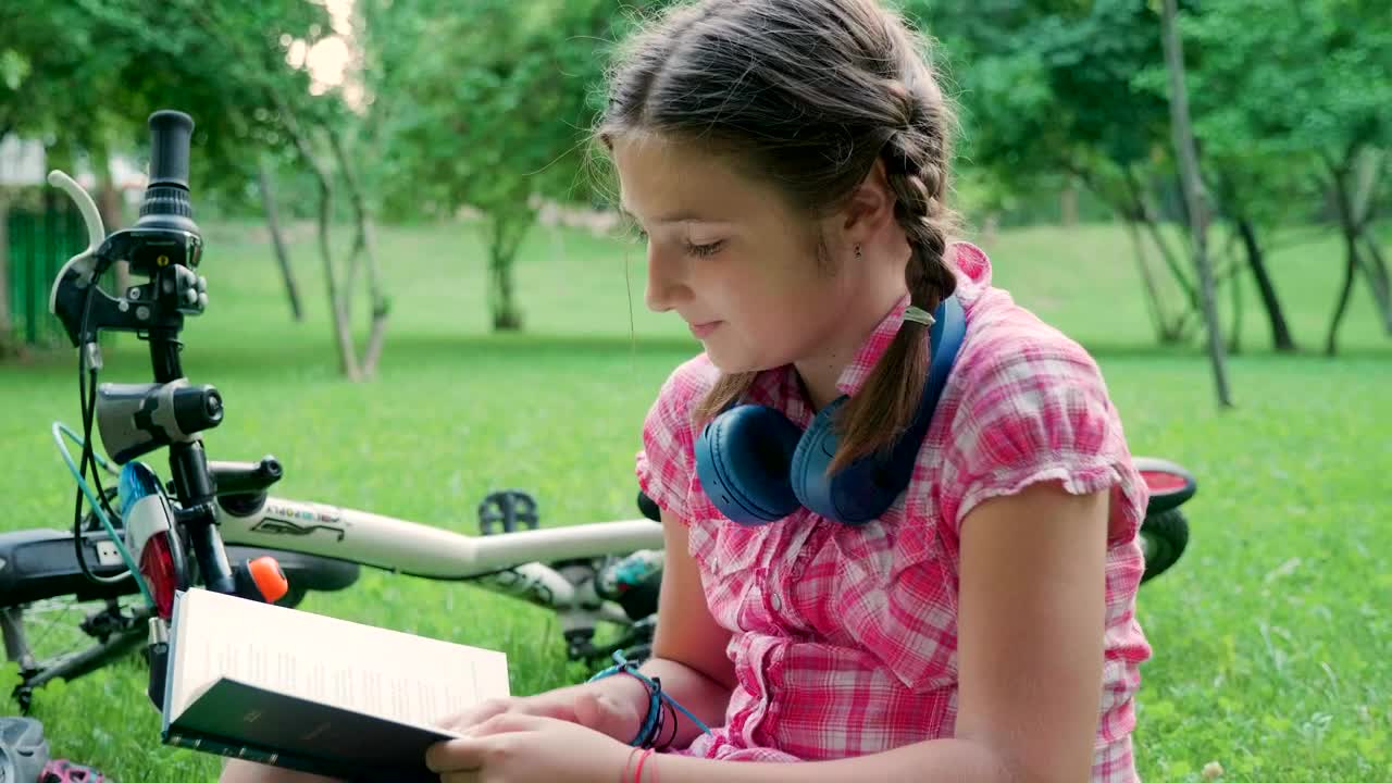 Download Stock Video Girl Reading Outside Next To Her Bike Live Wallpaper For PC