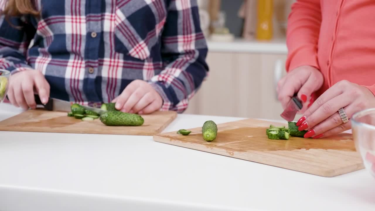 Download Stock Video Girl Helps Mom Chop Vegetables In Kitchen Live Wallpaper For PC