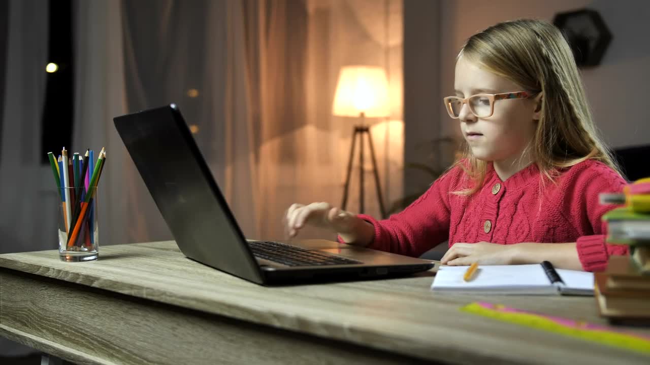 Download Stock Video Girl Doing Her Homework At A Desk With A Computer Live Wallpaper For PC