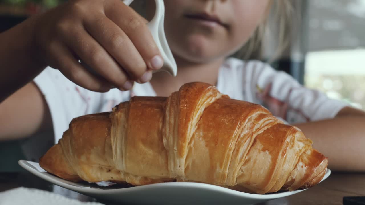 Download Stock Video Girl Adding Sweet Milk On A Croissant Live Wallpaper For PC