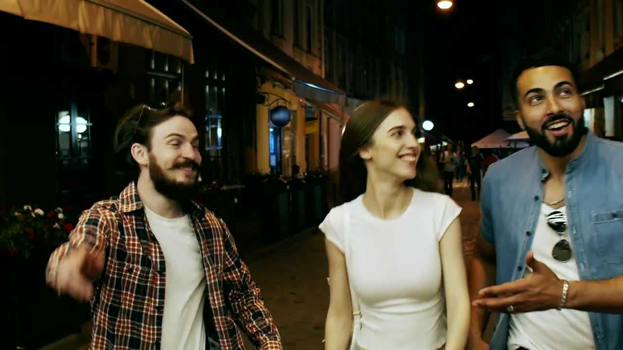 Download Stock Video Friends Laugh And Walk Down City Street At Night Live Wallpaper For PC