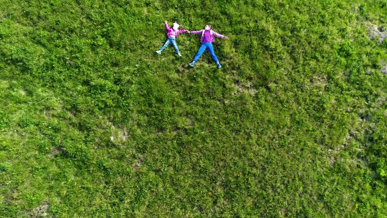 Download Stock Video Kids Layed In The Grass Top Aerial Shot Animated Wallpaper