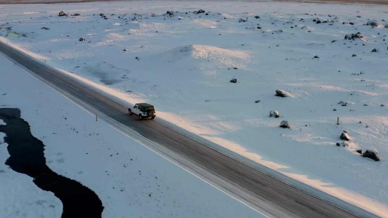 Download Stock Video Jeep Traveling A Road On A Road Surrounded By Snow Animated Wallpaper