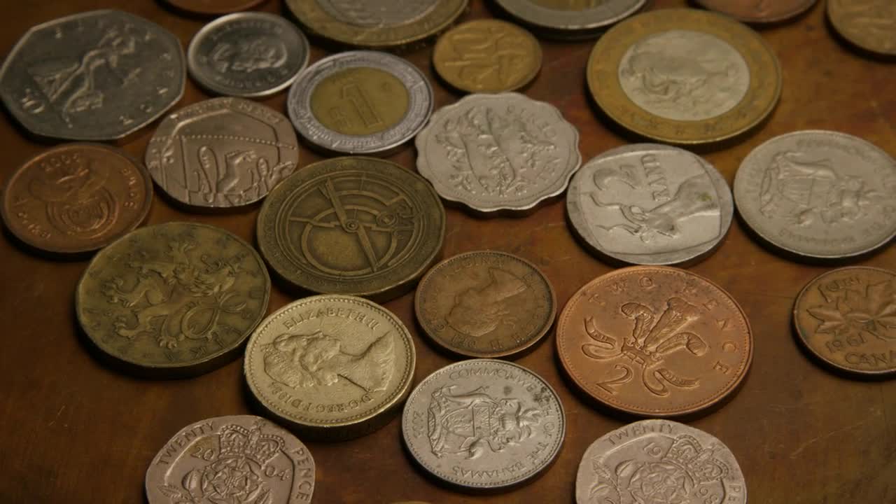 Download Stock Video International Coins On The Table Animated Wallpaper