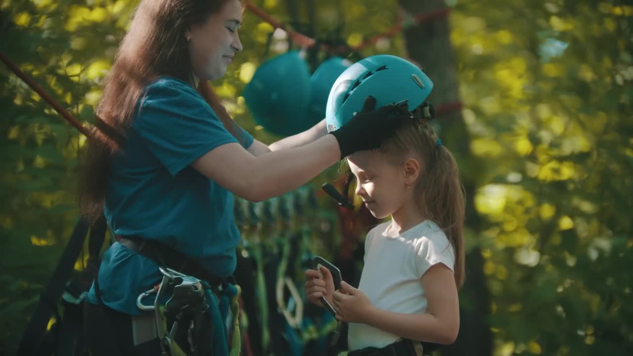 Download Stock Video Instructor Putting A Protective Helmet On A Little Girl Animated Wallpaper