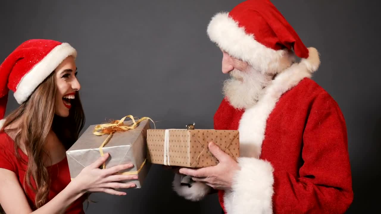 Download Stock Video Instagram Photoshoot Santa Claus And His Female Helper Animated Wallpaper