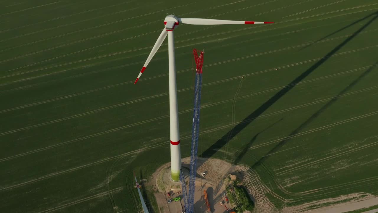 Download Stock Video Huge Wind Turbine Under Repair Seen From The Air Animated Wallpaper