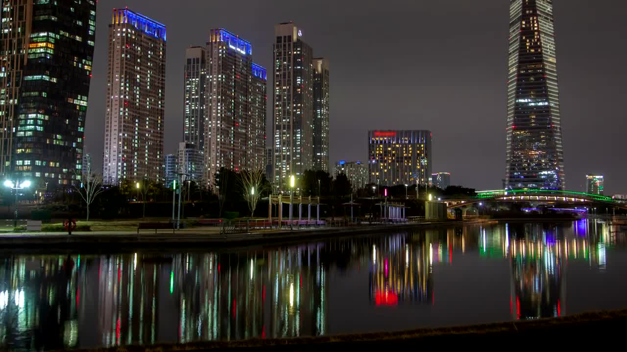 Download Stock Video Huge Skyscrapers Illuminated In Colors At Night Animated Wallpaper