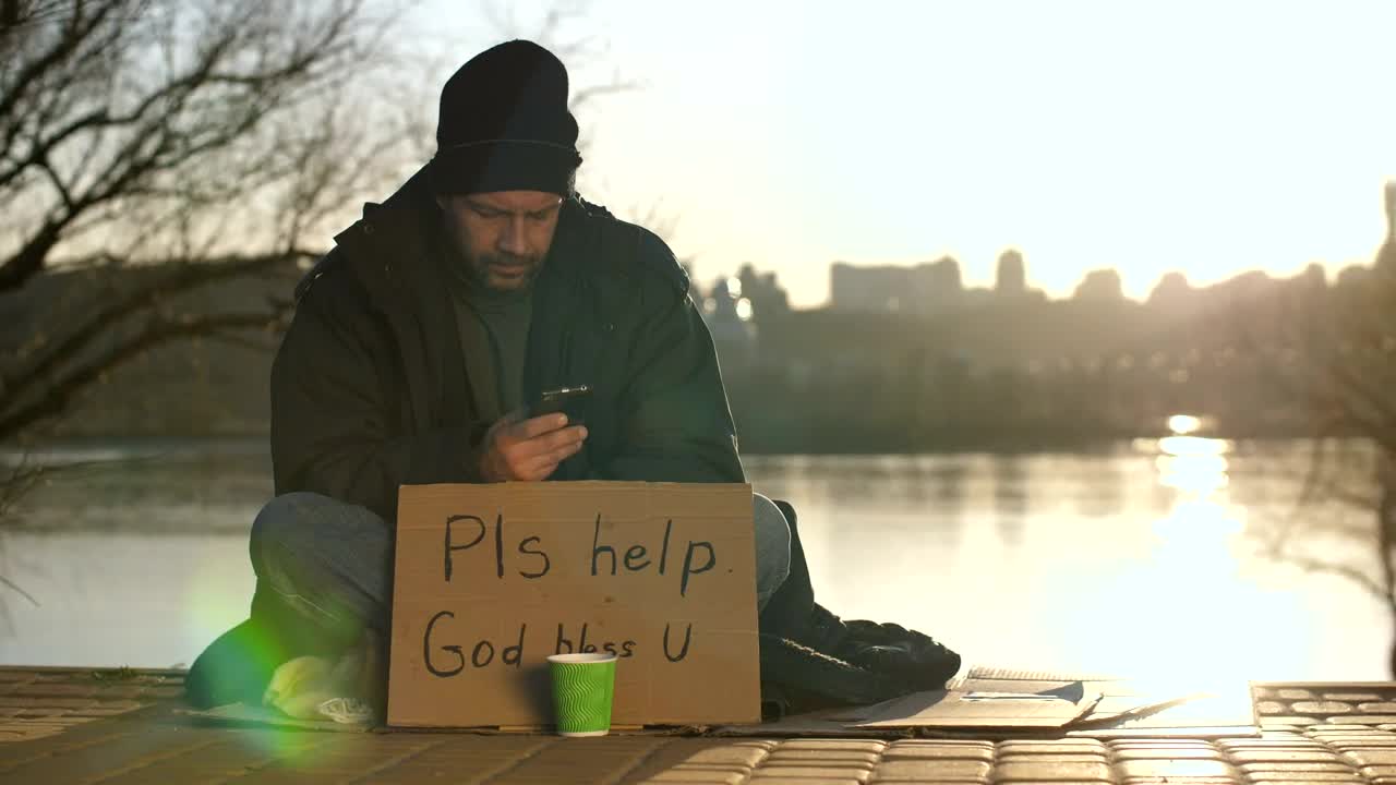 Download Stock Video Homeless Man With A Smartphone Animated Wallpaper