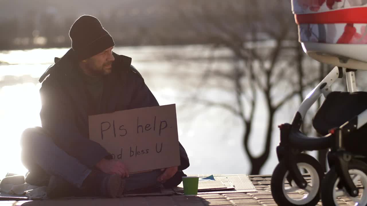 Download Stock Video Homeless Man On The Street With A Cardboard Sign Animated Wallpaper