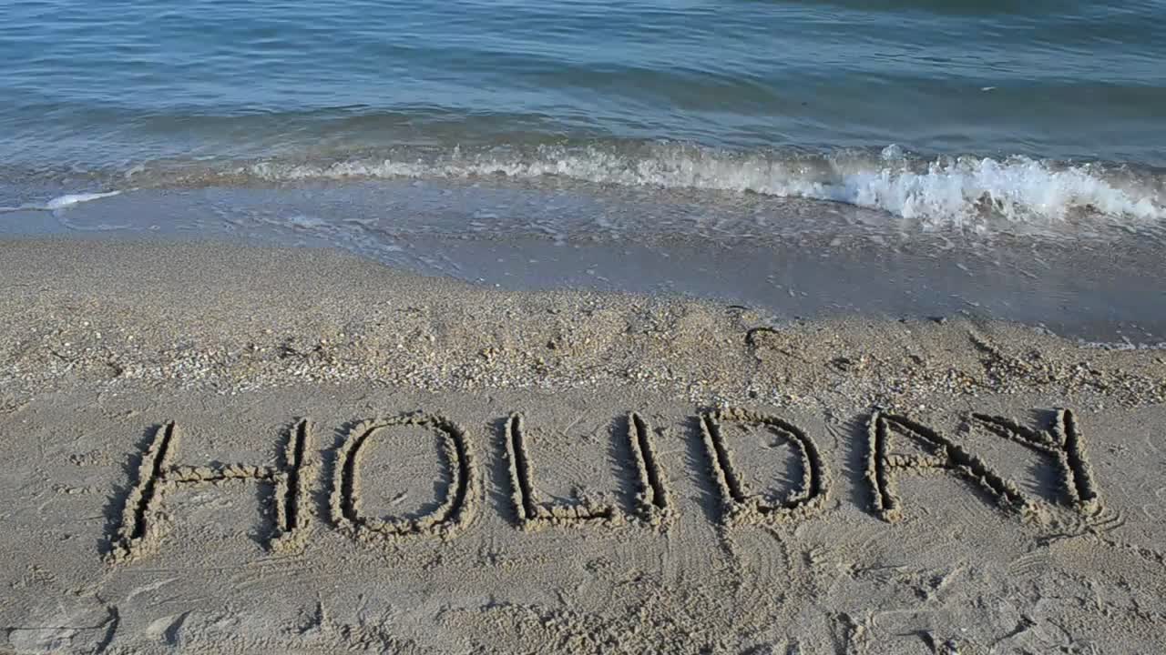 Download Stock Video Holiday Written In The Sand Near The Sea Animated Wallpaper