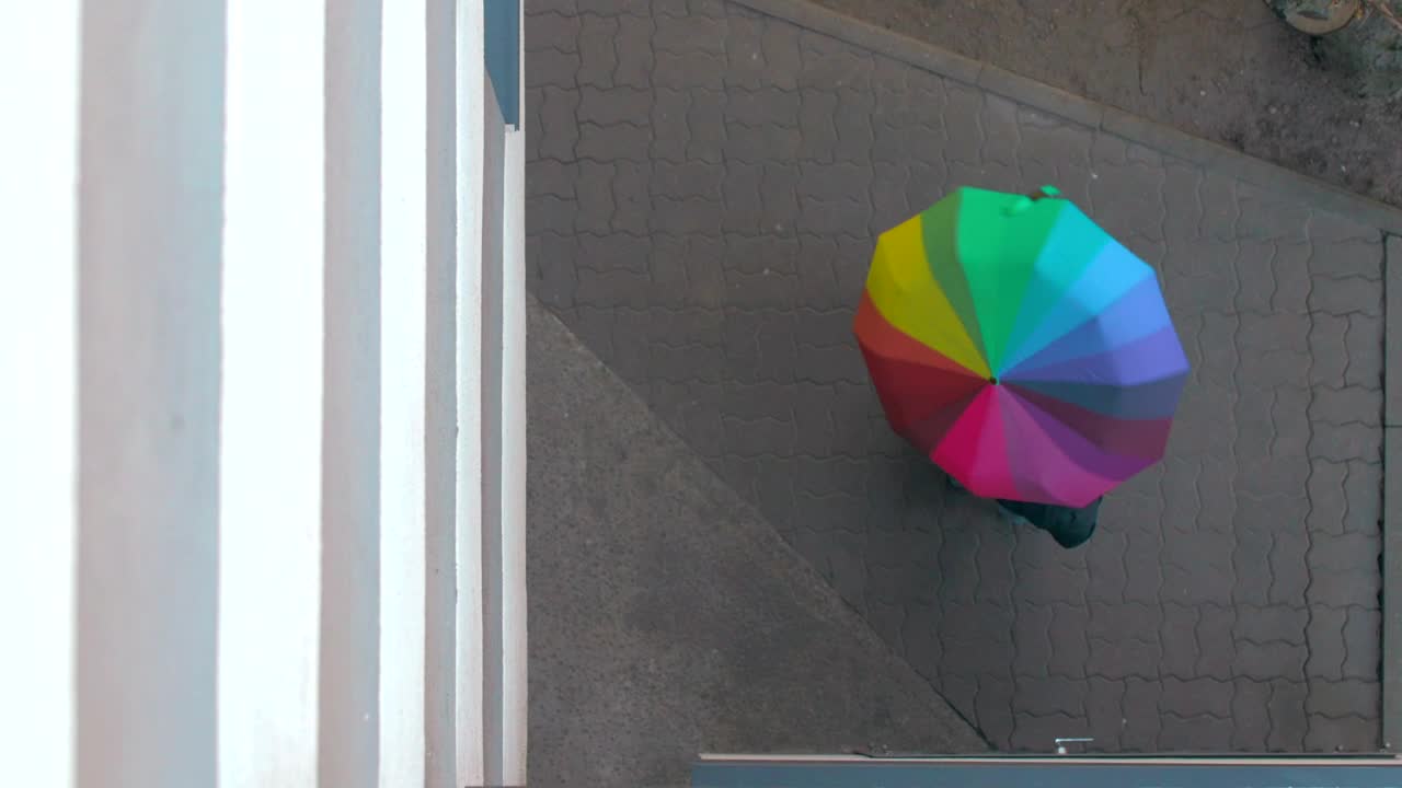 Download Stock Video Holding A Rainbow Umbrella Outside Animated Wallpaper