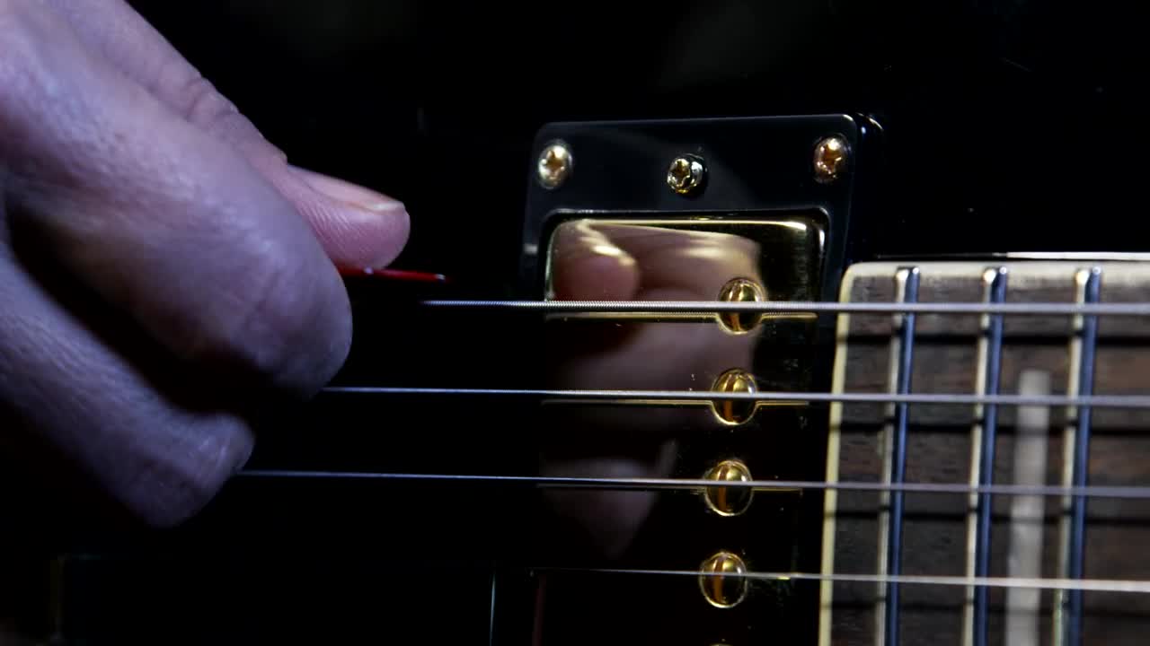 Download Stock Video Holding A Guitar Pick Animated Wallpaper