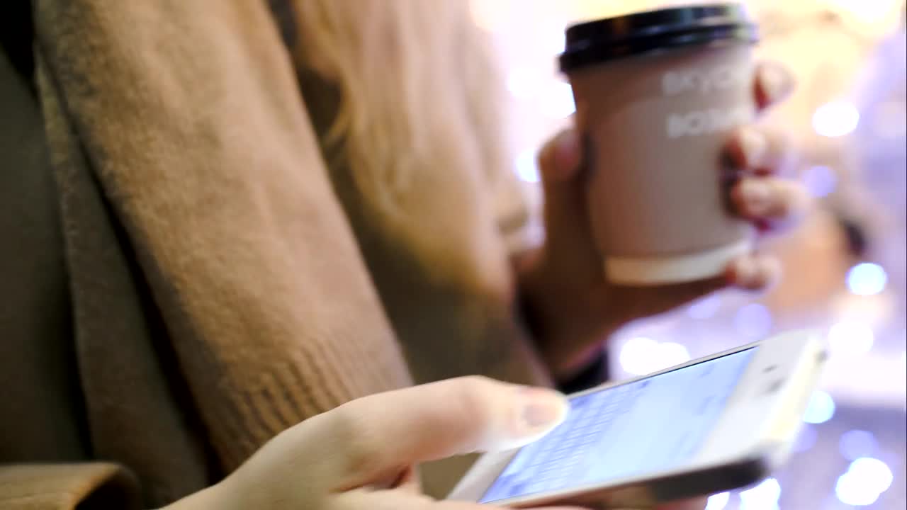 Download Stock Video Holding A Coffee And Texting Animated Wallpaper