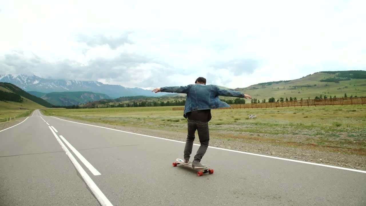 Download Stock Video Hipster Man On A Longboard On The Road Animated Wallpaper