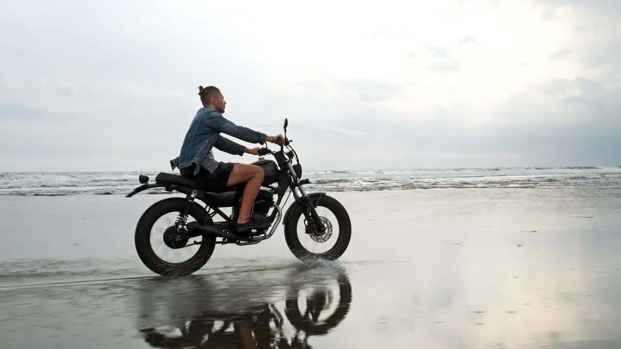 Download Stock Video Hipster Biker Riding A Motorcycle Near The Seashore Animated Wallpaper