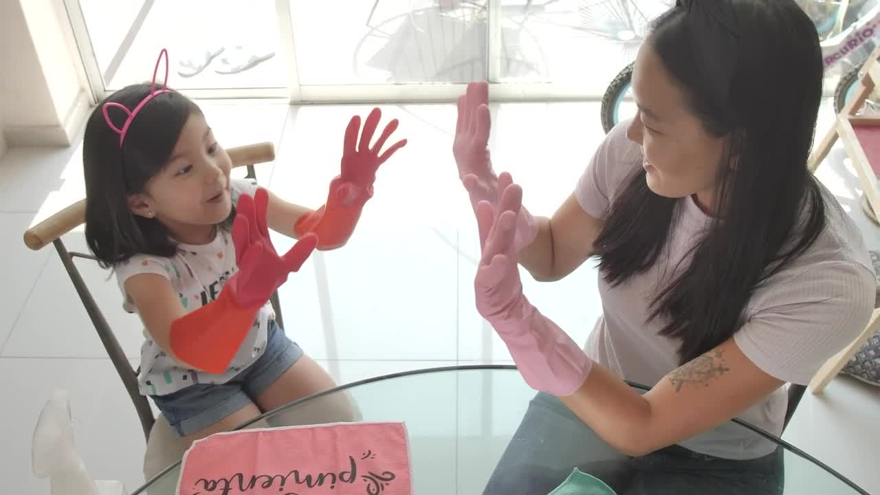 Download Stock Video Hi Five Between Mother And Daughter For Cleaning Their House Animated Wallpaper