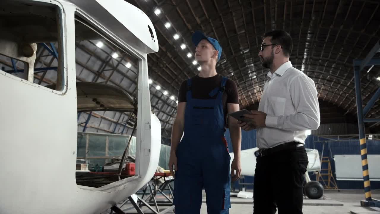 Download Stock Video Having A Conversation In The Hangar Animated Wallpaper