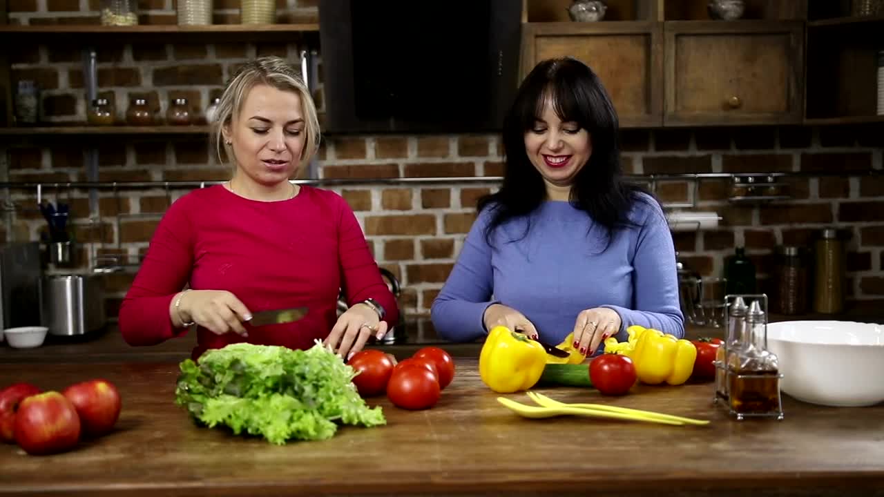 Download Stock Video Happy Women Cutting Vegetables At Home Animated Wallpaper