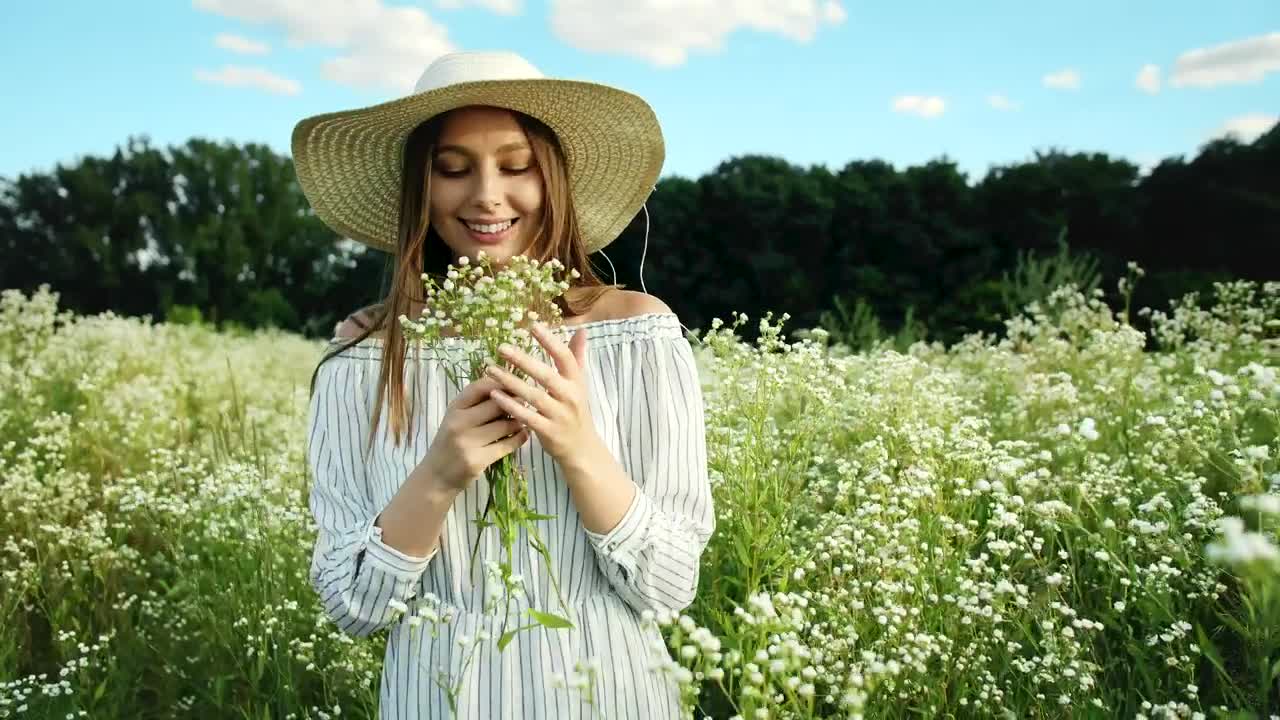 Download Stock Video Happy Woman In A Flower Field Animated Wallpaper