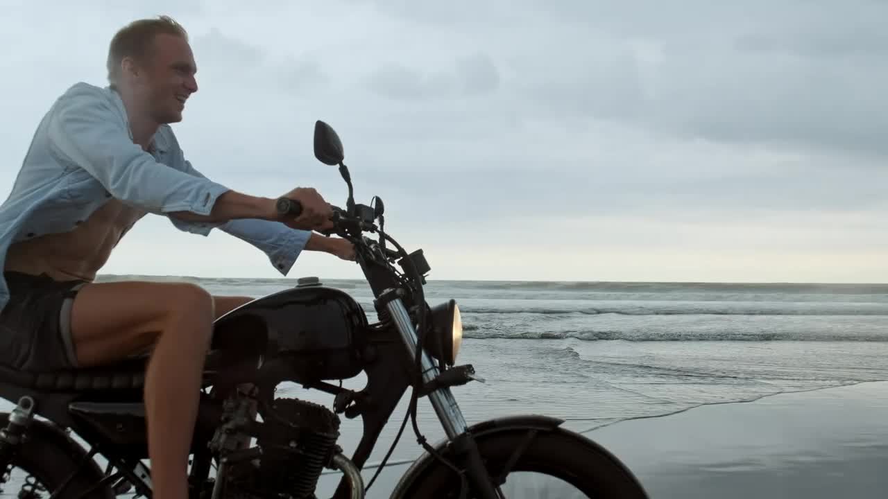 Download Stock Video Happy Wanderlust Riding A Motorcycle At The Beach Animated Wallpaper