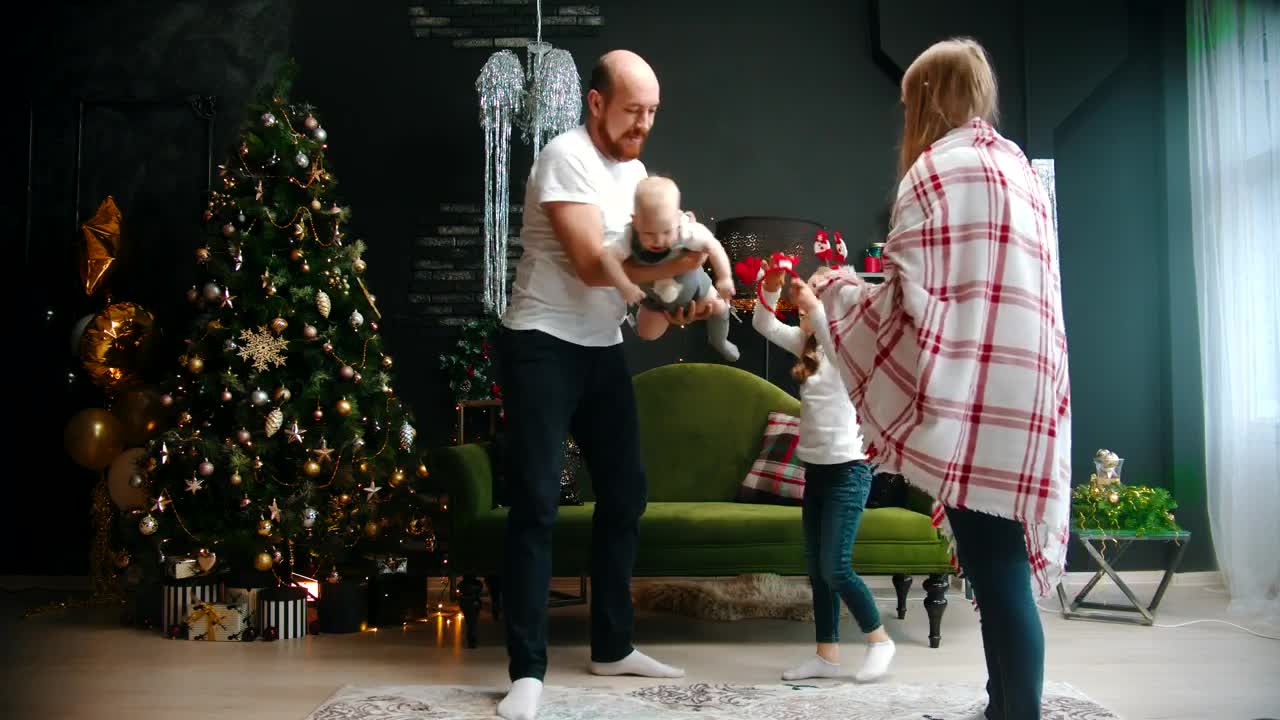 Download Stock Video Happy Parents Play With Their Daughters At Christmas Animated Wallpaper