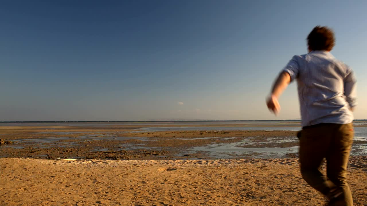 Download Stock Video Happy Man Running At Low Tide Animated Wallpaper