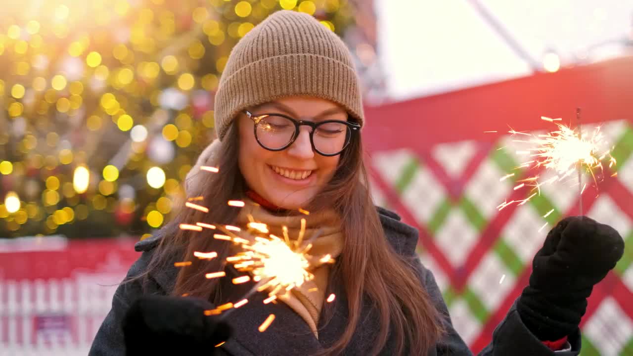 Download Stock Video Happy Girl Holding Sparkles At Christmas Animated Wallpaper