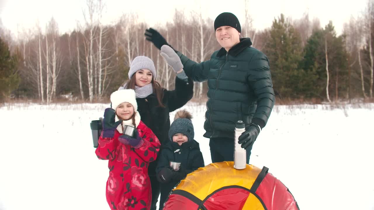 Download Stock Video Happy Family Waving In A Snowy Forest Animated Wallpaper