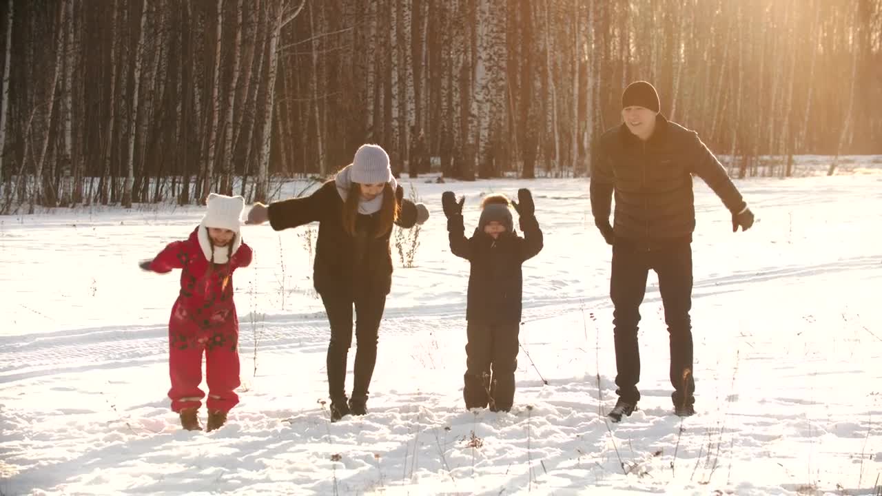 Download Stock Video Happy Family Jumps In The Snow In A Forest Animated Wallpaper