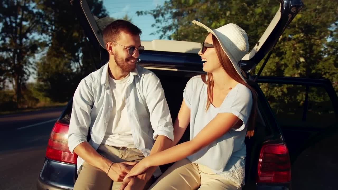 Download Stock Video Happy Couple Holding Hands Before Their Roadtrip Animated Wallpaper