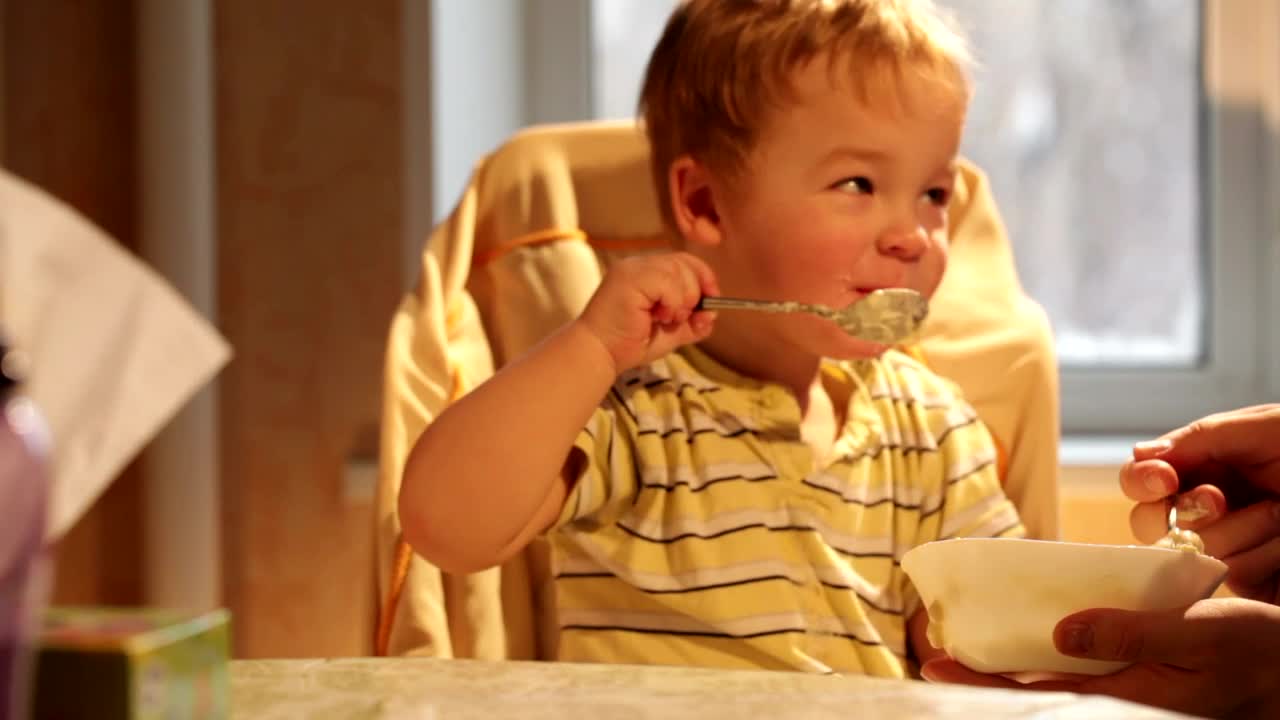 Download Stock Video Happy Child Eating Breakfast Animated Wallpaper