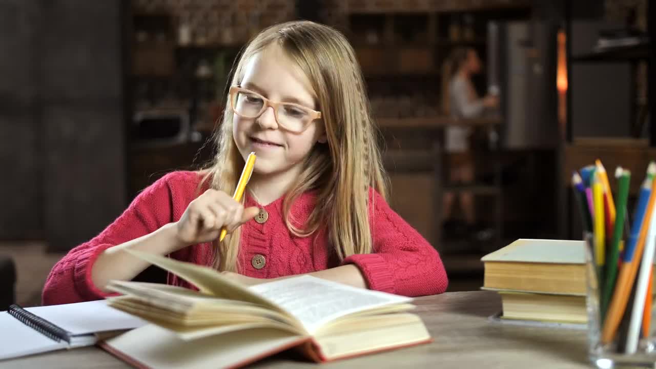 Download Stock Video Happy Child Doing Her Homework Animated Wallpaper