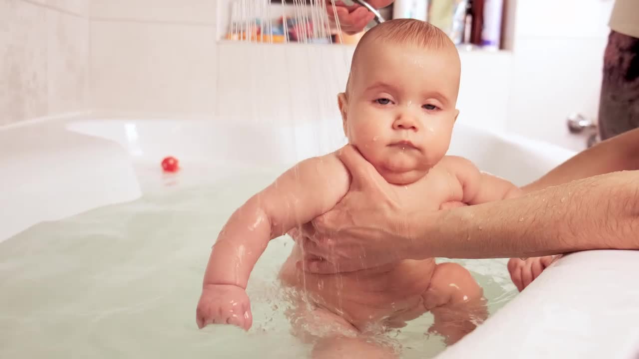 Download Stock Video Happy Baby Being Bathed In The Tub Animated Wallpaper