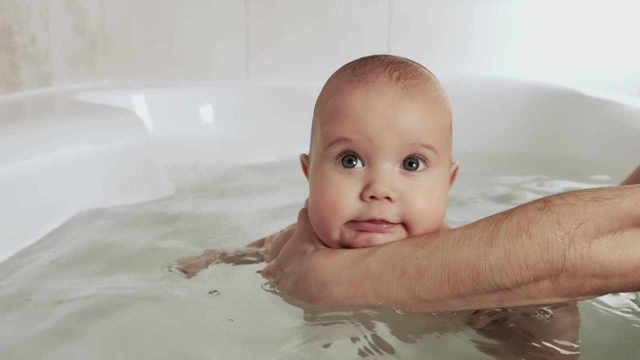 Download Stock Video Happy Baby Being Bathed By His Mother Animated Wallpaper