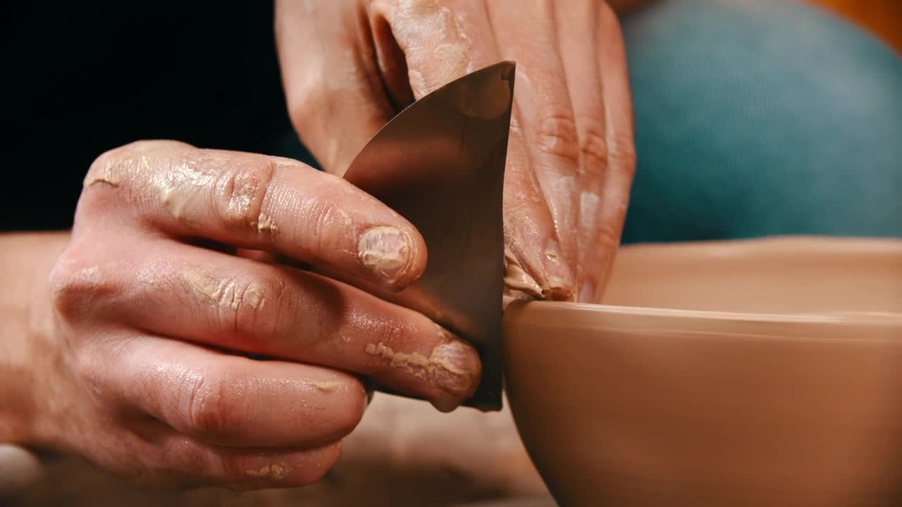 Download Stock Video Hans Molding A Clay Bowl With A Metal Tool Animated Wallpaper