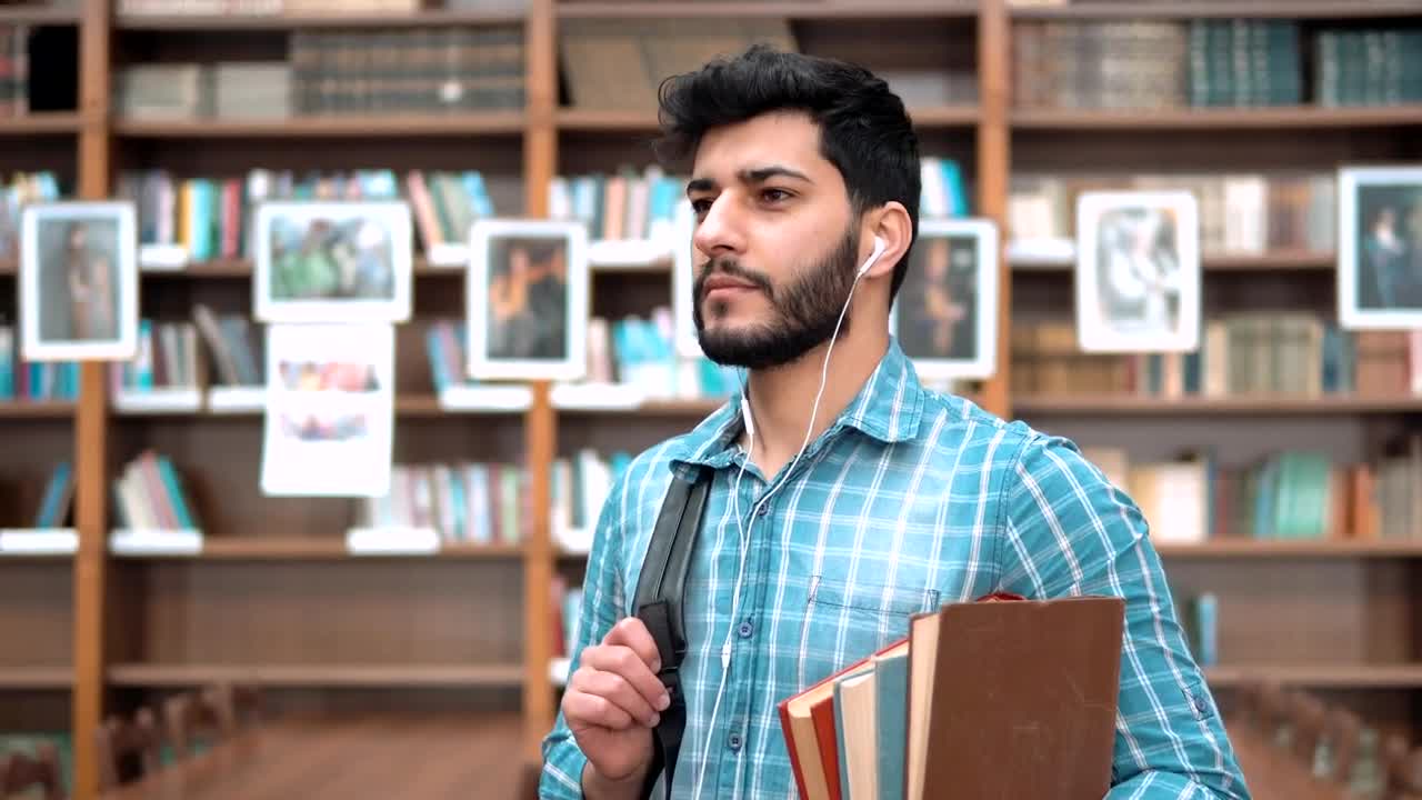 Download Stock Video Handsome Smiling University Student With Books Animated Wallpaper