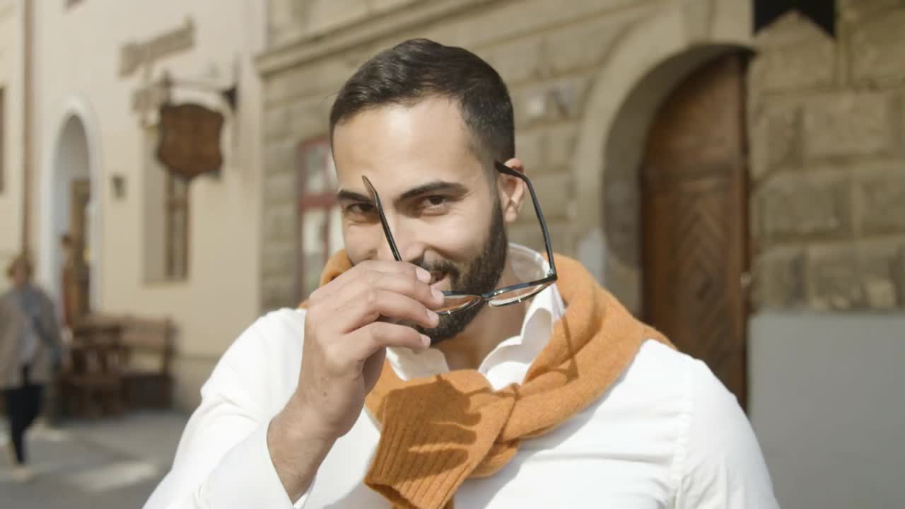 Download Stock Video Handsome Arab Man Takes Off Glasses And Smiles Animated Wallpaper