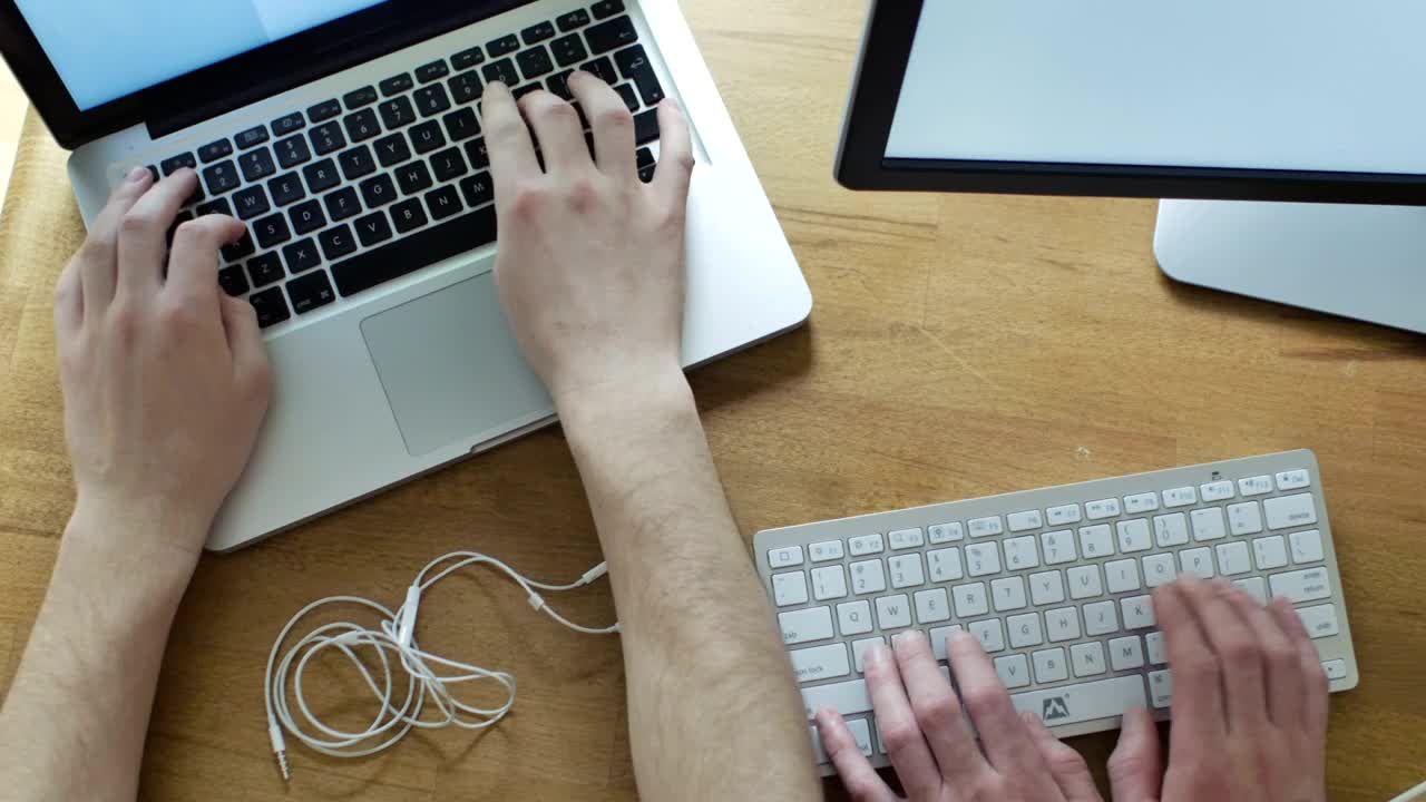 Download Stock Video Hands Working On Different Keyboards On A Desk Animated Wallpaper