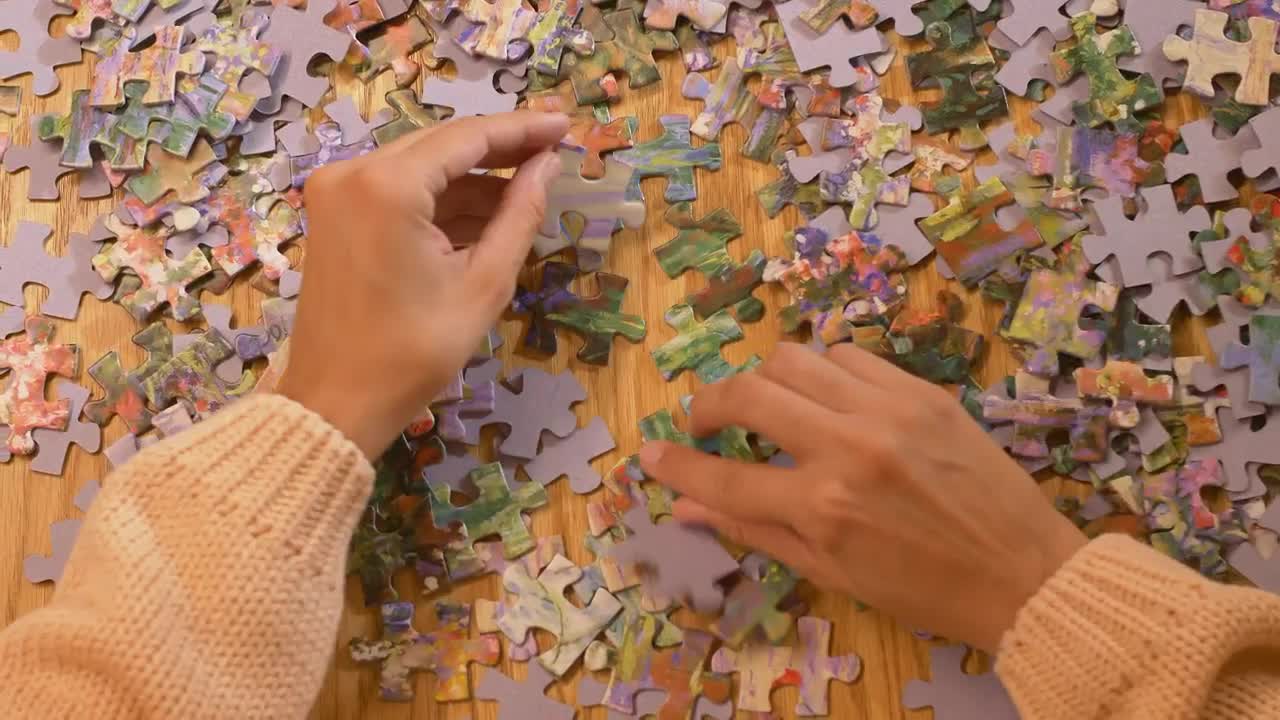 Download Stock Video Hands Of A Woman Playing With A Puzzle Animated Wallpaper