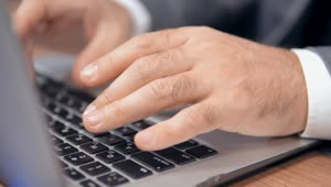 Download Stock Video Hands Of A Man Typing On A Laptop Animated Wallpaper