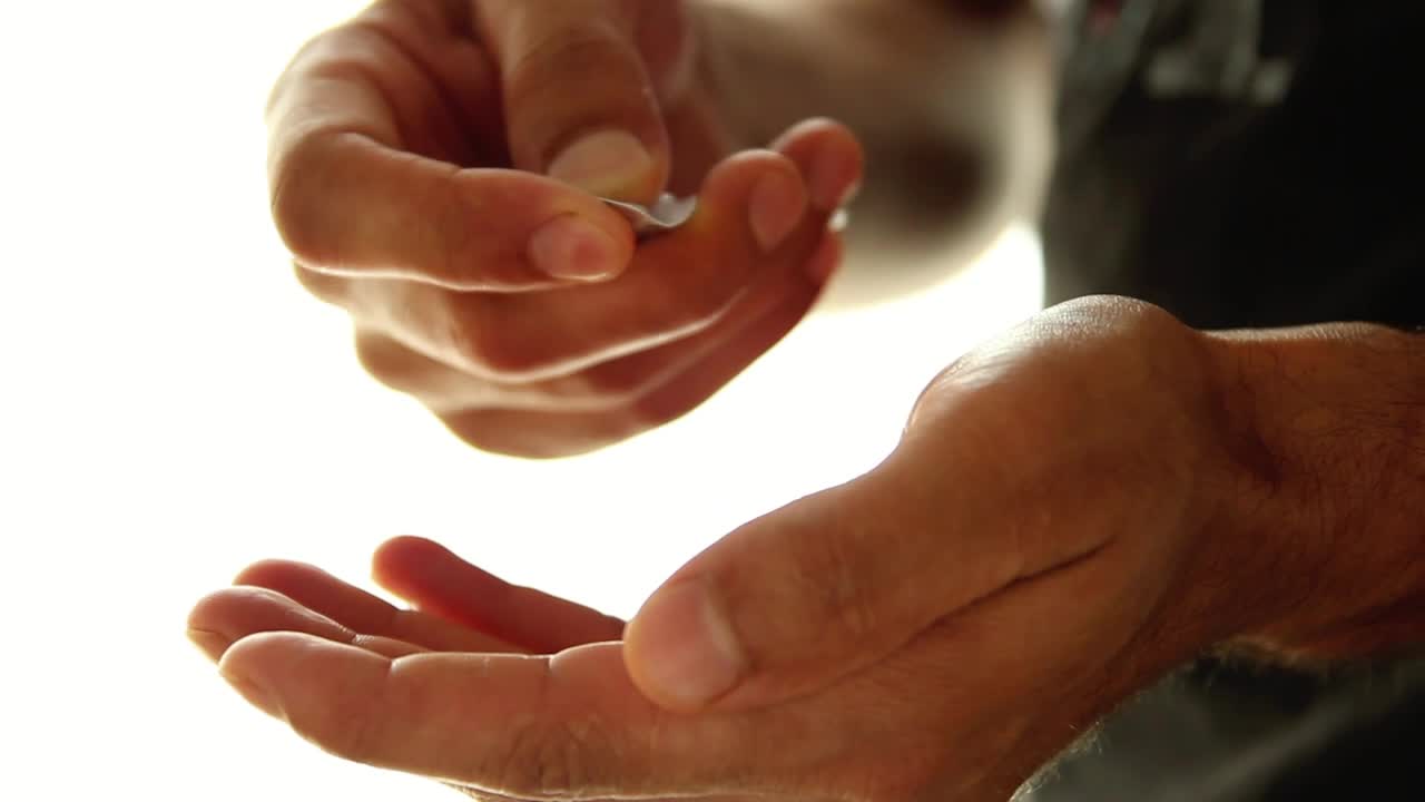 Download Stock Video Hands Of A Man Taking Pills From A Packaging Animated Wallpaper