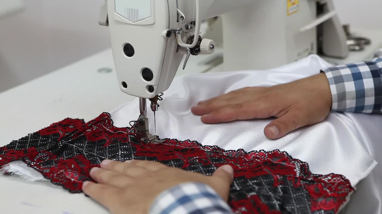 Download Stock Video Hands Of A Man Sewing On A Machine Animated Wallpaper