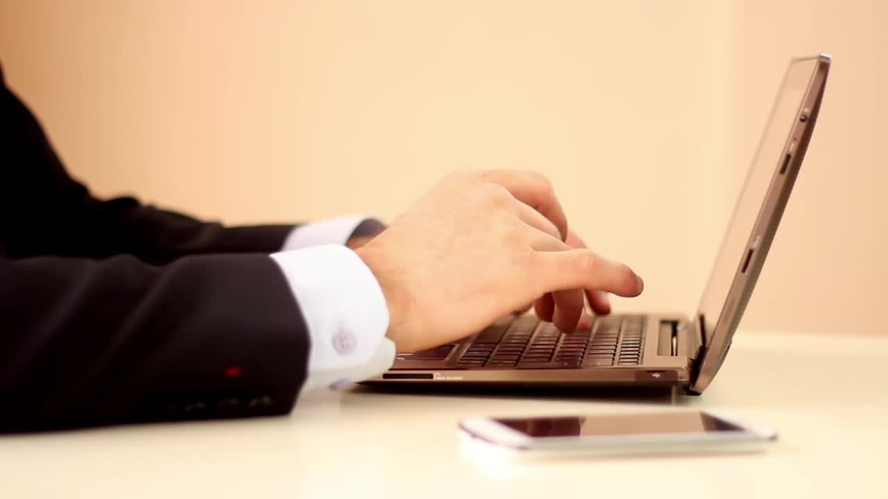 Download Stock Video Hands Of A Man In Suit Working On A Computer Animated Wallpaper