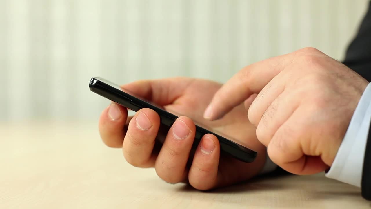 Download Stock Video Hands Of A Man In A Suit Using His Smartphone Animated Wallpaper