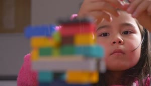 Download Stock Video Hands Of A Girl Putting Together A Figure With Legos Animated Wallpaper