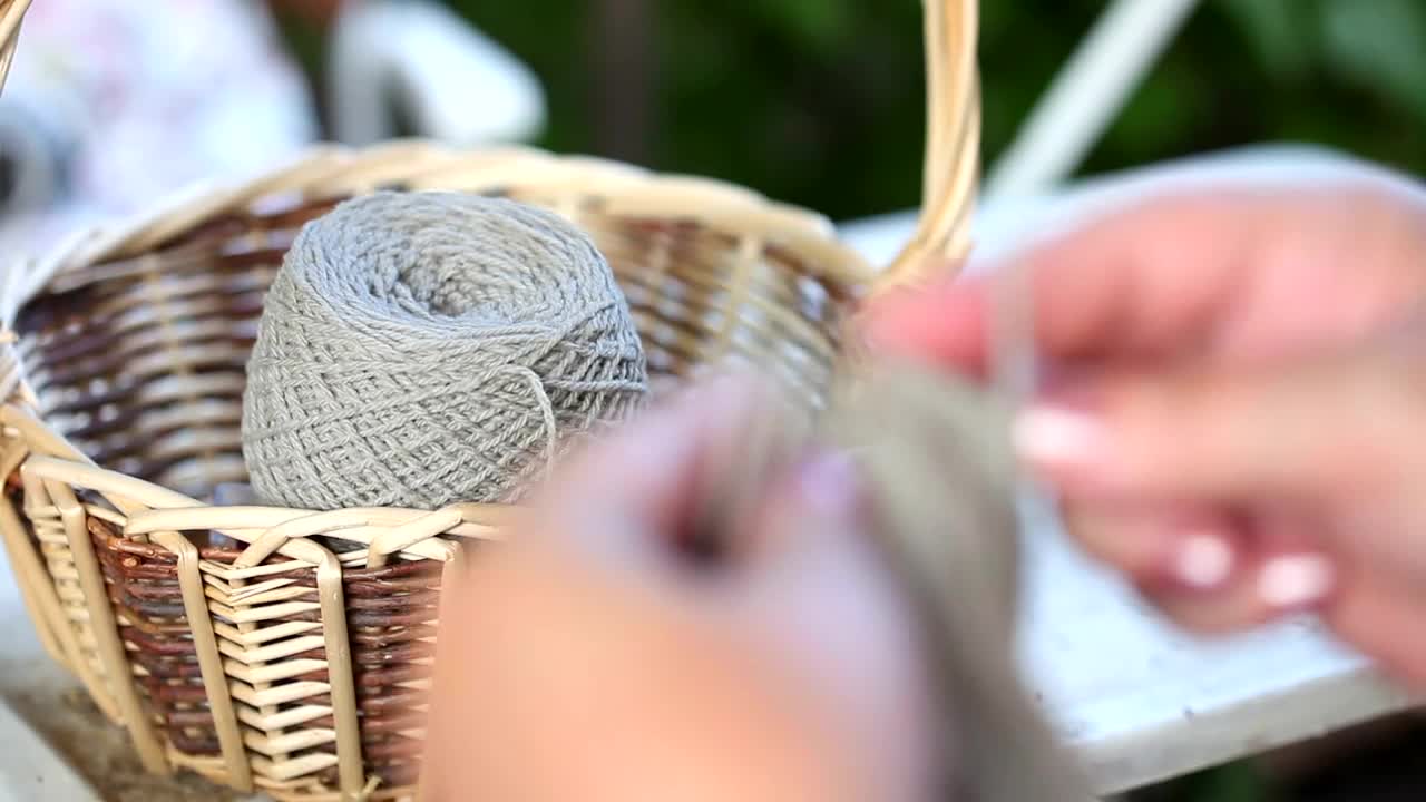 Download Stock Video Hands Knitting With Big Needles Animated Wallpaper