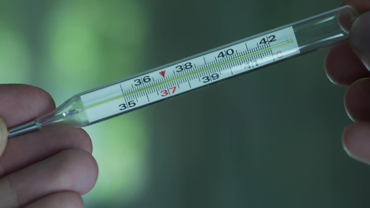 Download Stock Video Hands Holding Thermometer Animated Wallpaper