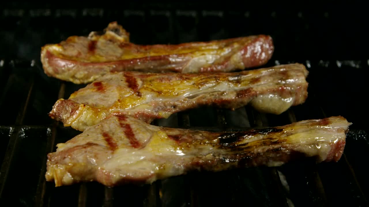 Download Stock Video Lamb Ribs Cooking On A Grill Animated Wallpaper