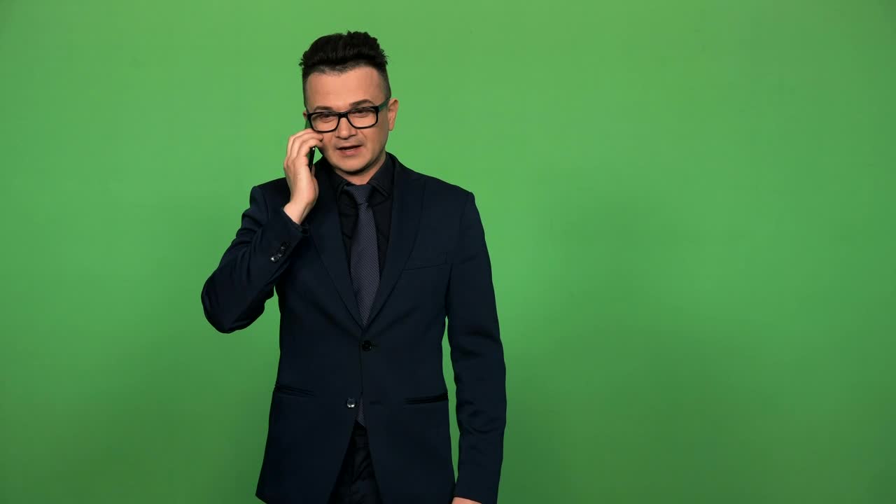 Download Stock Video Man In Suit And Glasses Answering A Phone Call Animated Wallpaper